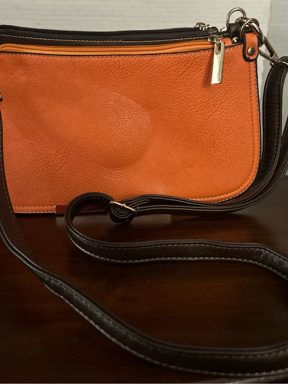 Sleek Orange Leather Crossbody with Black Strap